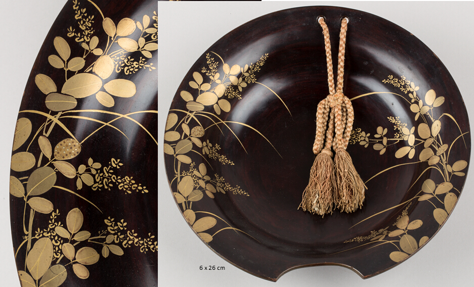 Shallow round shaving basin with a semicircular cutout on its rim and a plaited cord with tassel on the opposite side. Decorated with gold hira-makie on red (bengara) ground depicting autumn plant foliage.