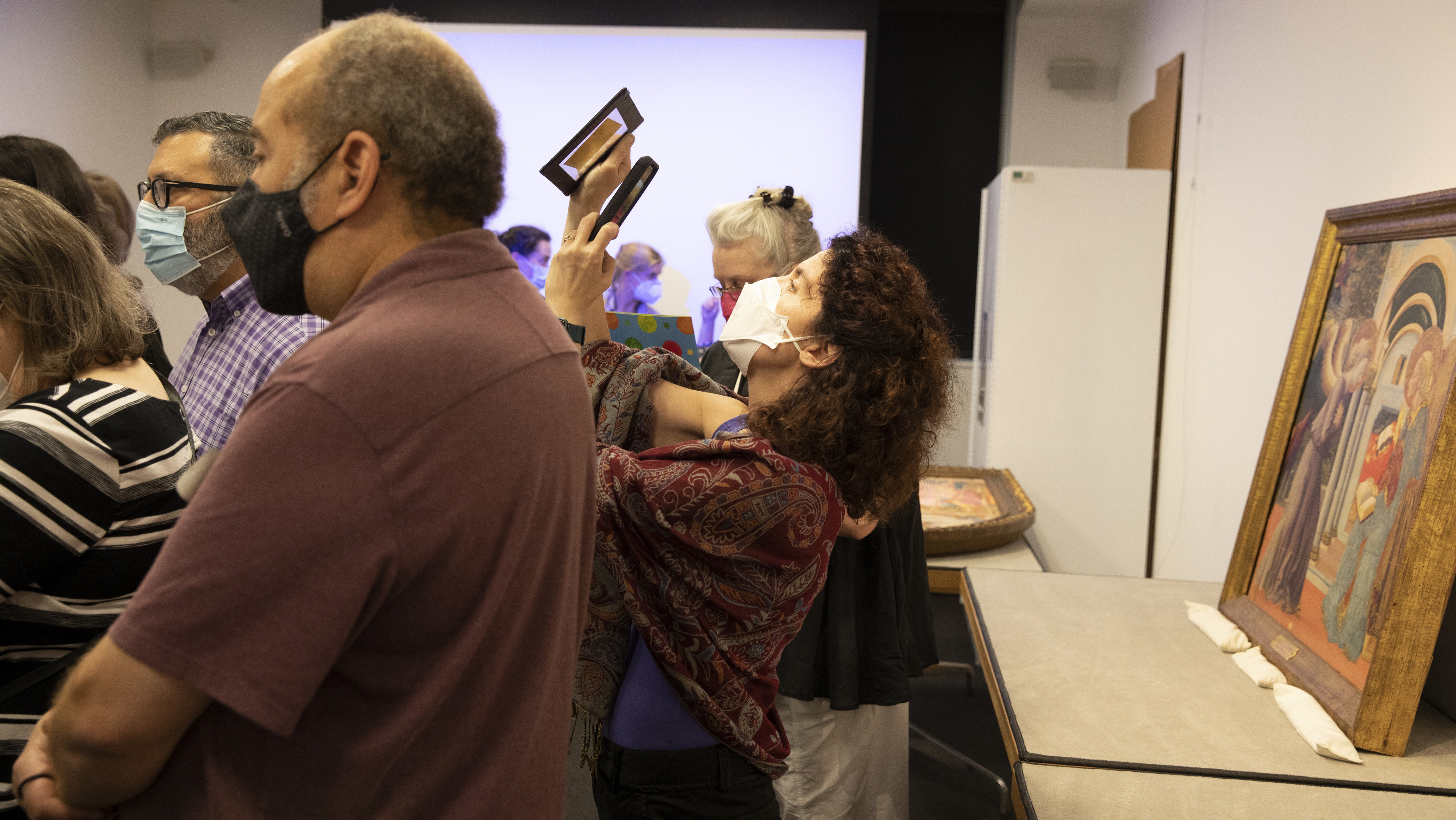  Interior of YUAG study room showing many standing STITAH participants including one examining two transparent images.